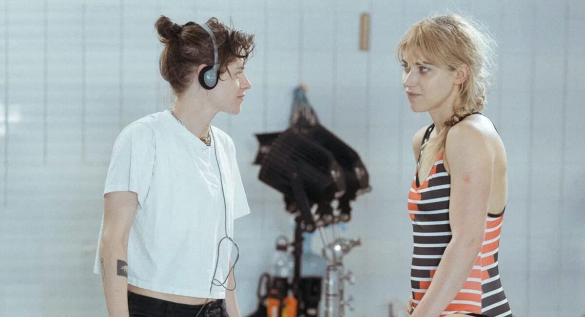 Two women looking at each other across video camera